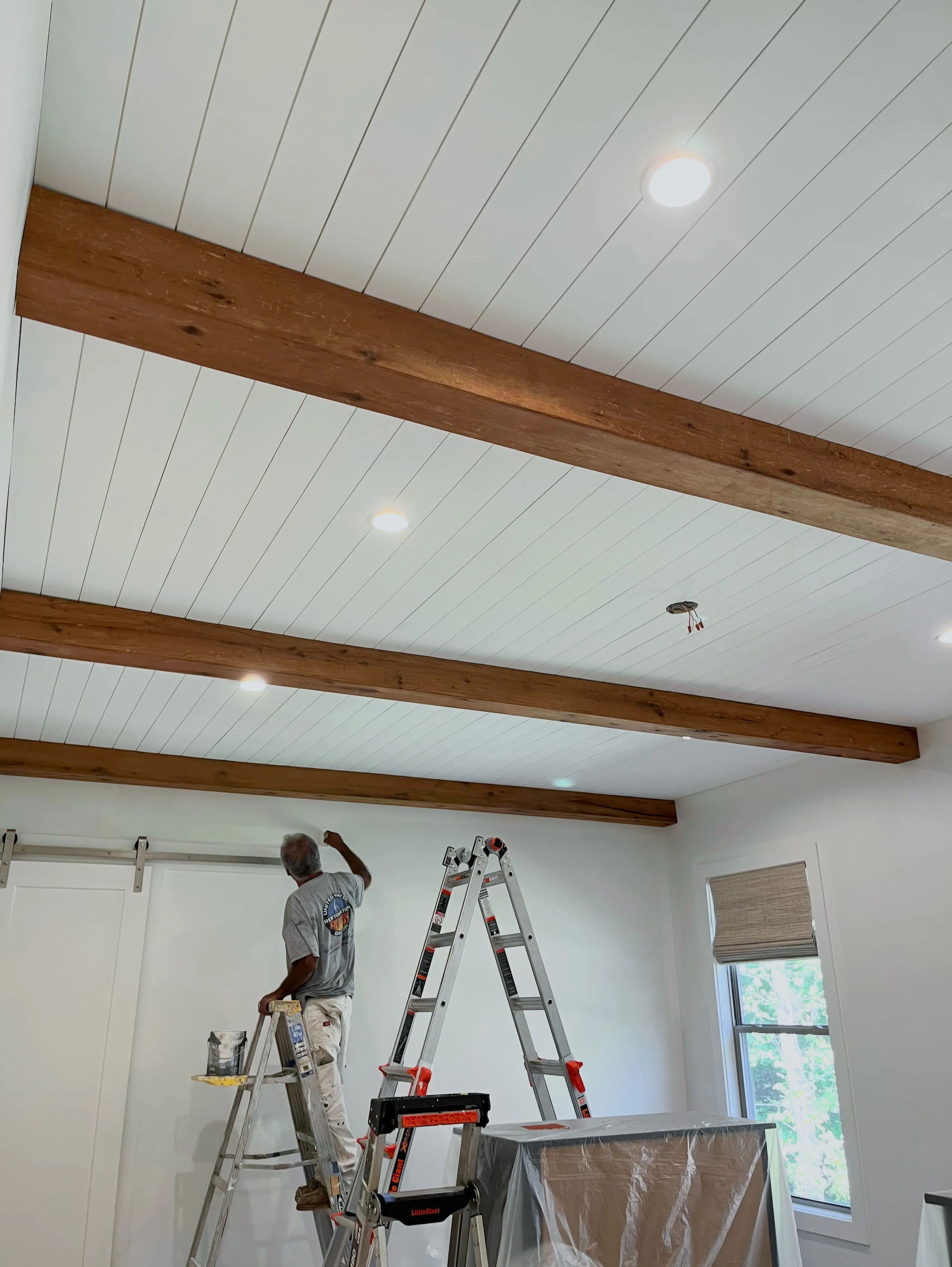 Wood Beams being installed in bedroom.
