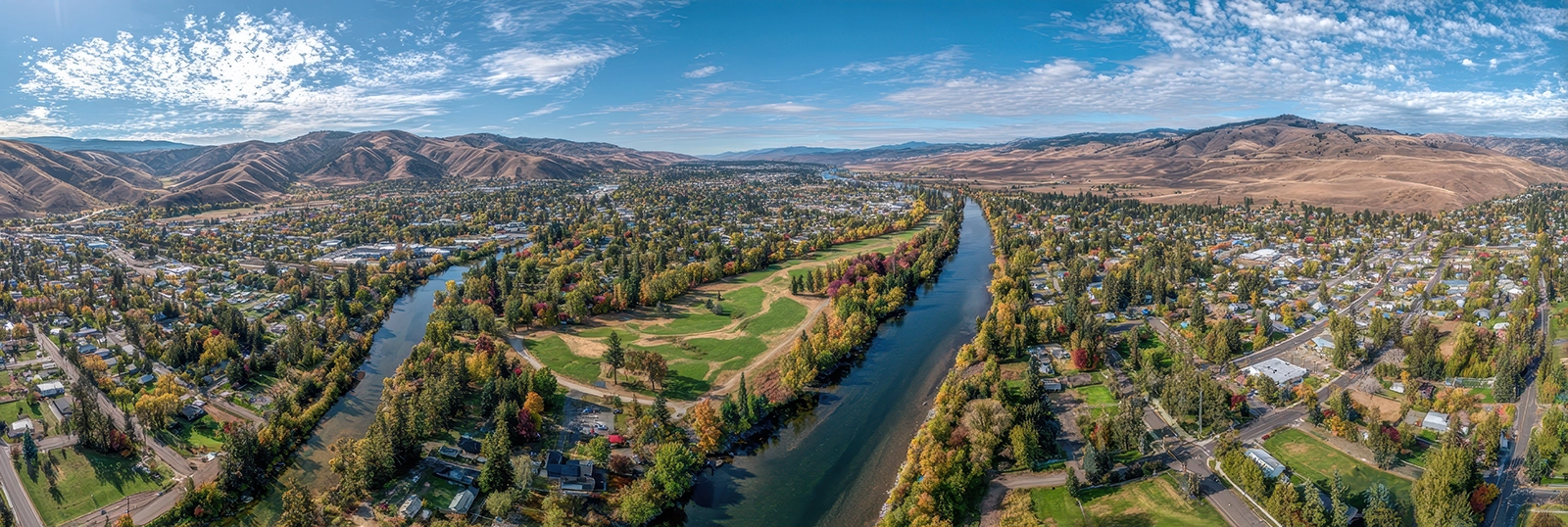 Group of medical professionals at The Eye Center in scrubs and surgical caps standing together in a clinical room with medical equipment.