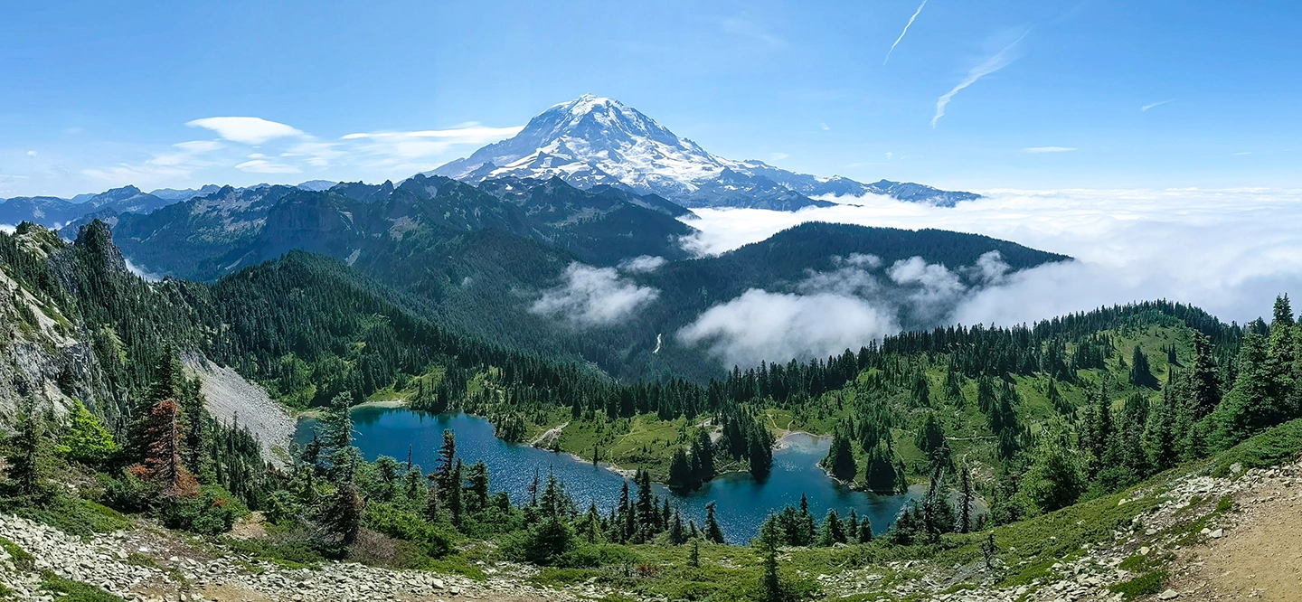 Group of medical professionals at The Eye Center in scrubs and surgical caps standing together in a clinical room with medical equipment.