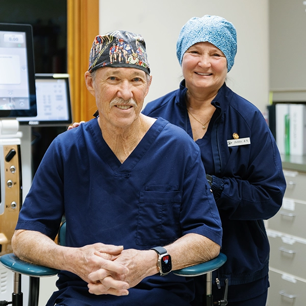 Dr. Ehlers and wife Debbie Ehlers RN in The Eye Center Office wearing scrubs