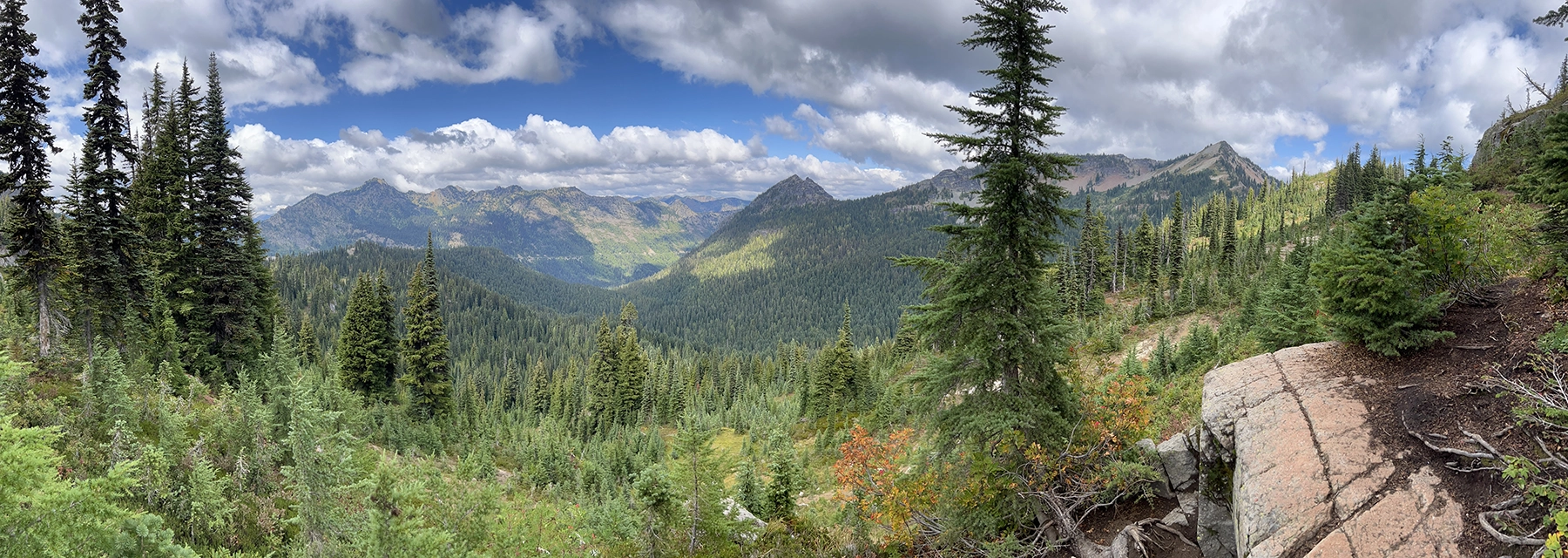 Group of medical professionals at The Eye Center in scrubs and surgical caps standing together in a clinical room with medical equipment.