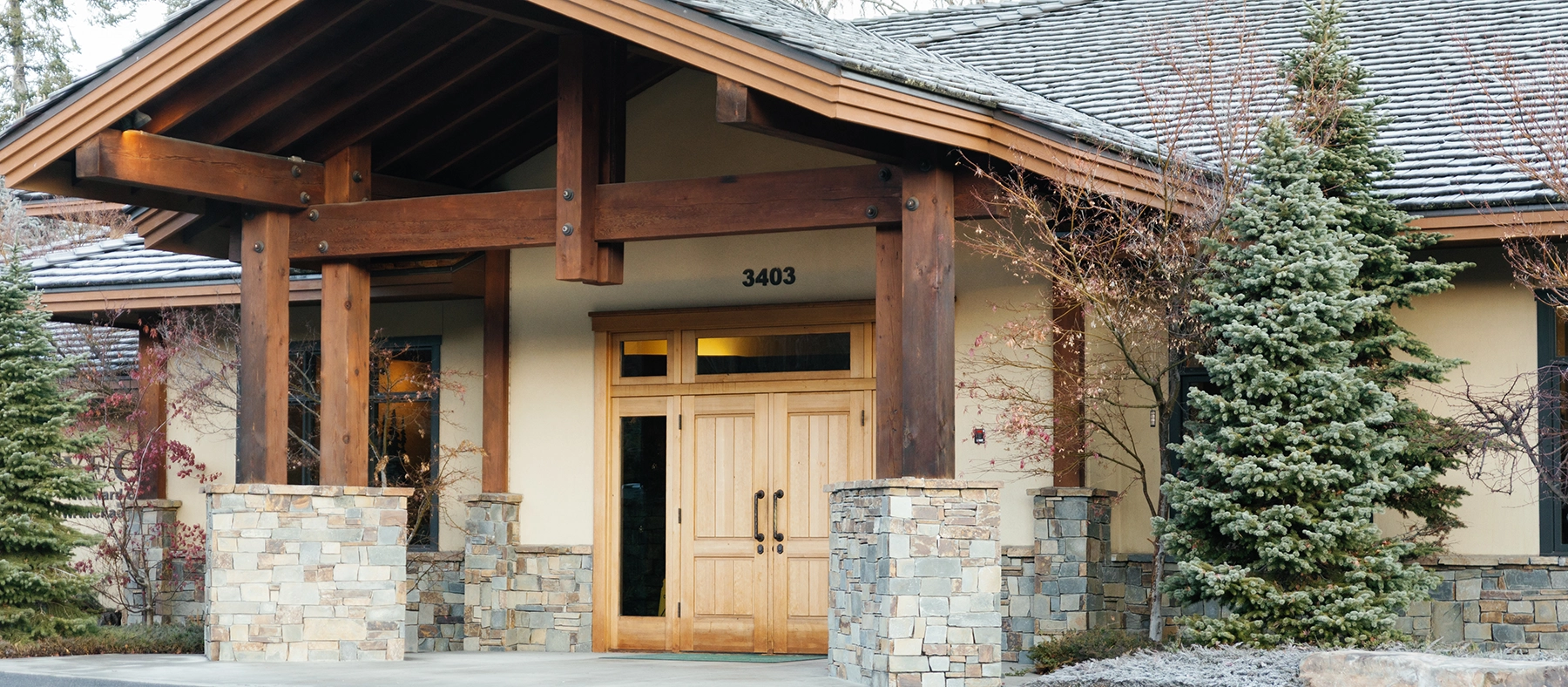Group of medical professionals at The Eye Center in scrubs and surgical caps standing together in a clinical room with medical equipment.