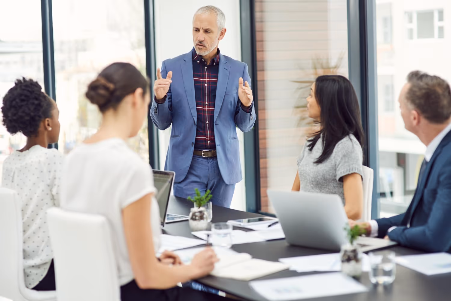 Executive presenting to a leadership team about technology and business alignment