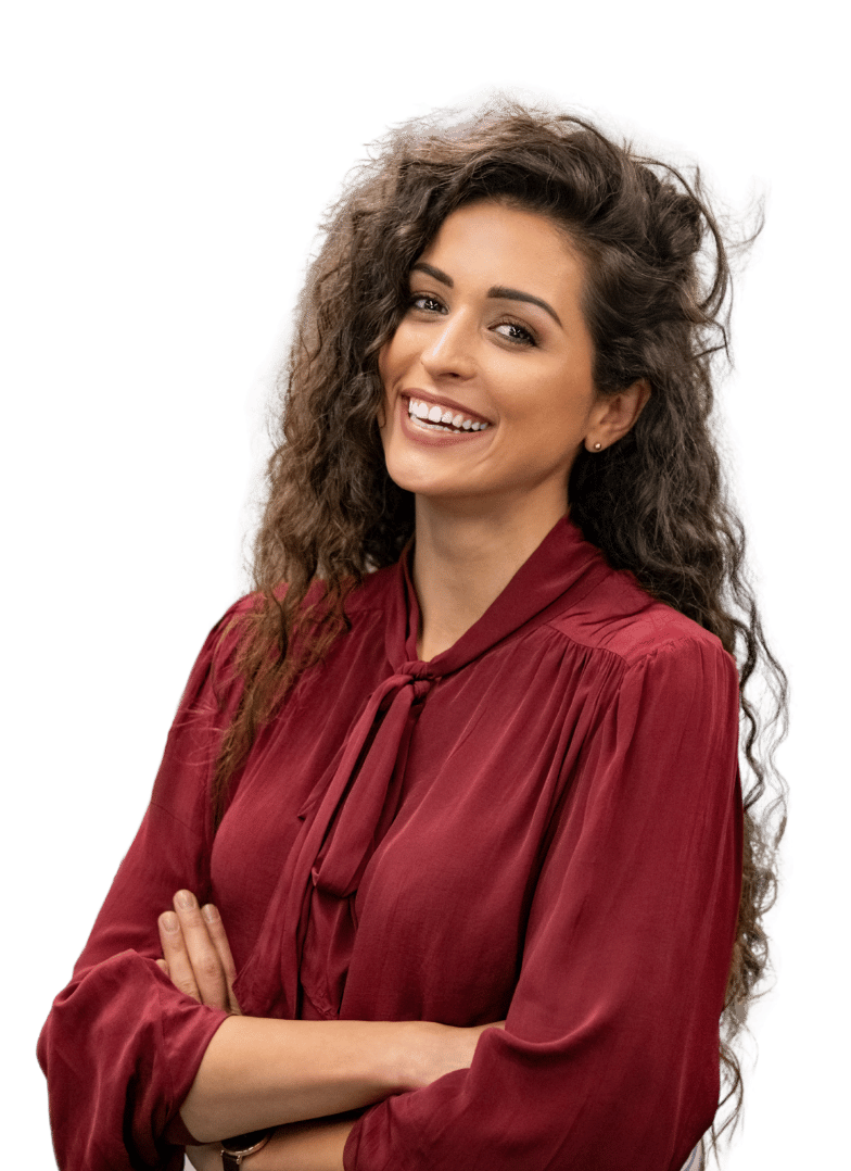 Smiling woman with curly hair wearing a red blouse, arms crossed.