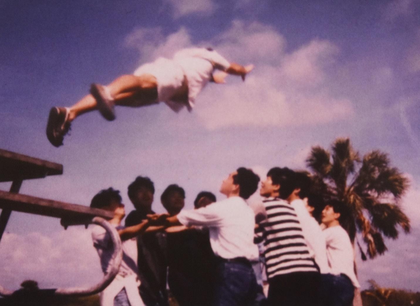 A group of people jumping in the airDescription automatically generated