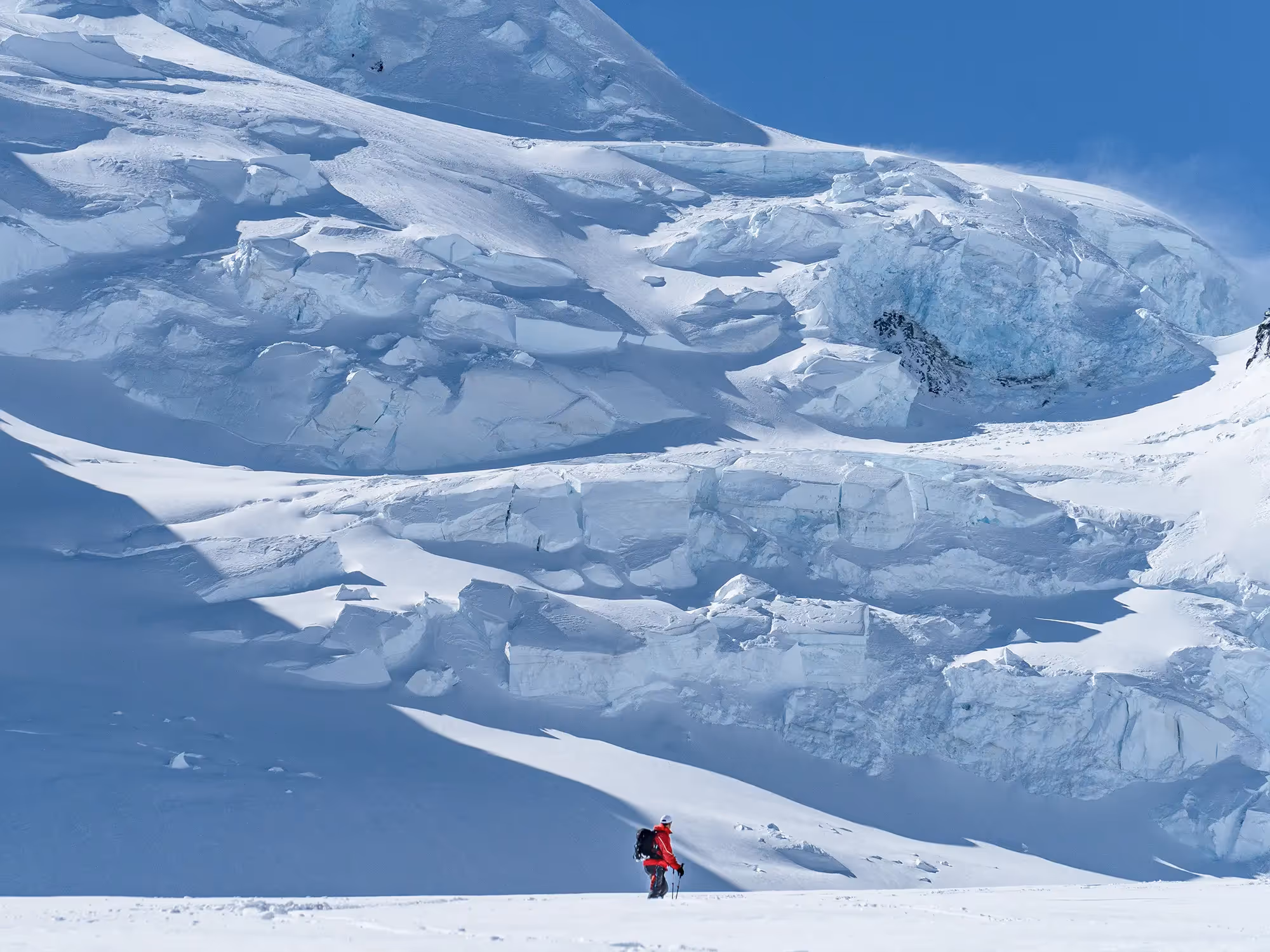 Skiers traversing glacier terrain