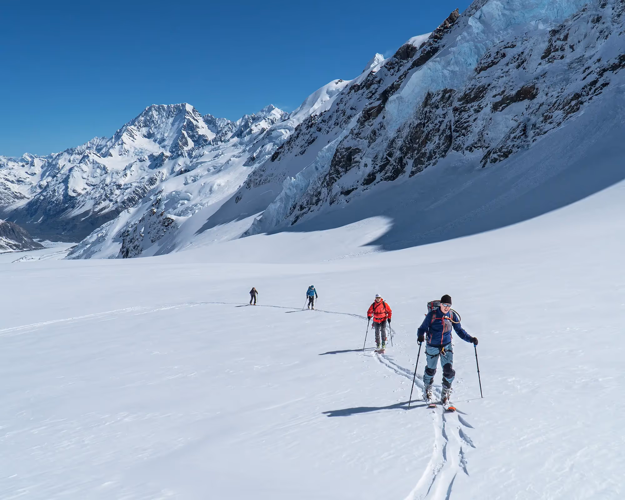 Skiers traversing glacier terrain