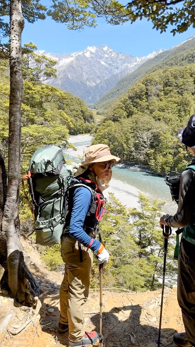 Climber hiking with backpack on trail