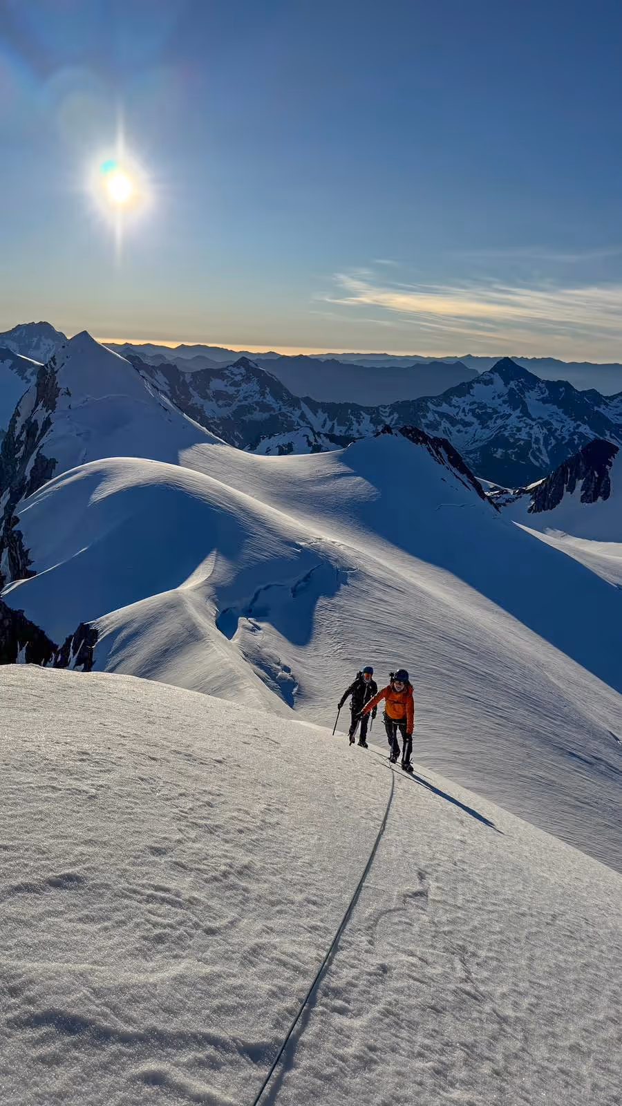 Climber ascending on snowy terrain