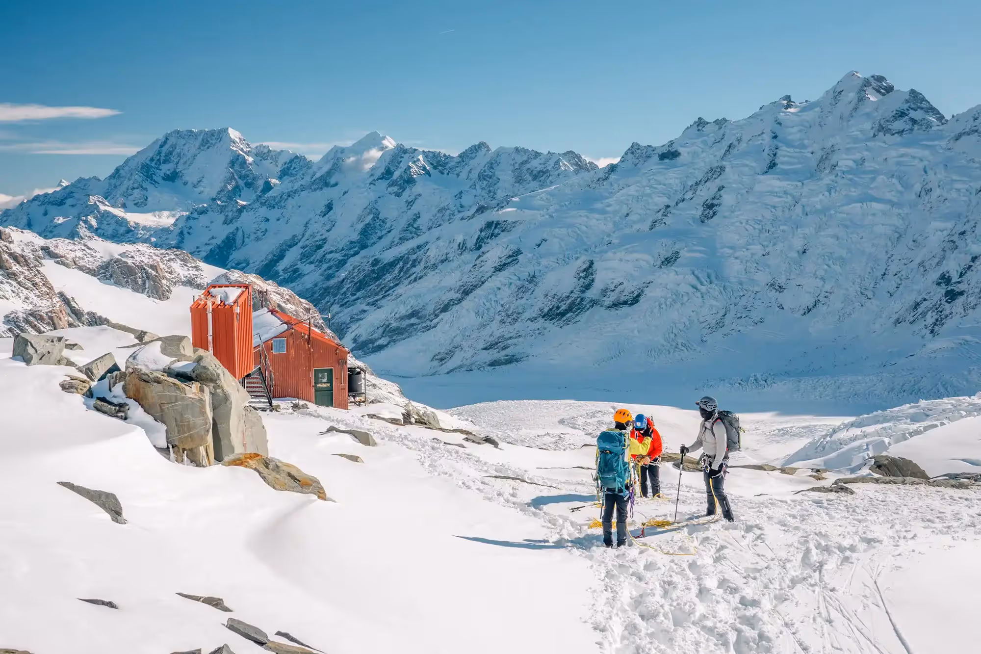 Alpine Skills Course participants outside Tasman Saddle Hut preparing for instruction.