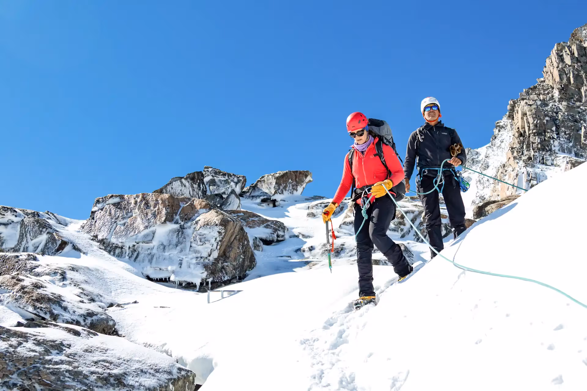 Alpine Skills Course two climbers descending snowy slope with crampons