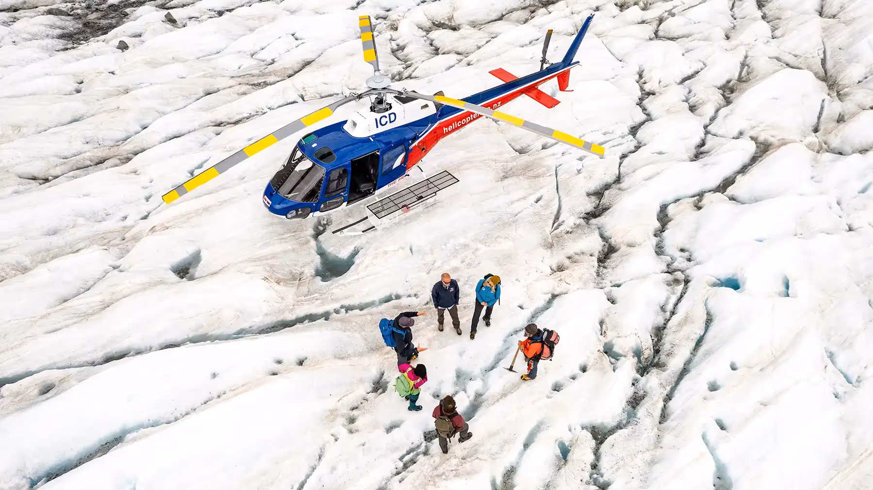 Exclusive Tasman Encounter drone view of helicopter and guests on glacier