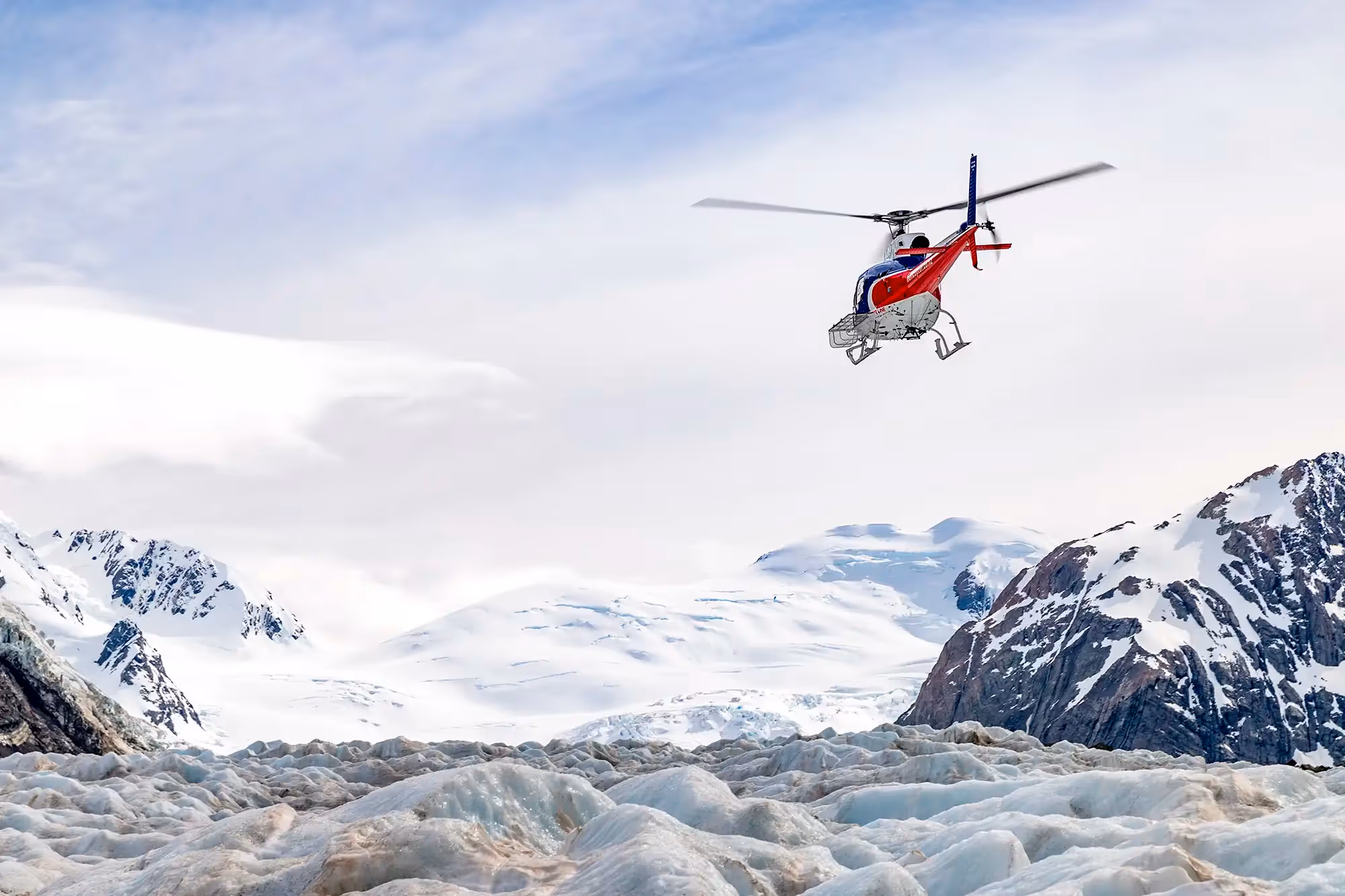 Exclusive Tasman Encounter helicopter flying toward Tasman Glacier white ice