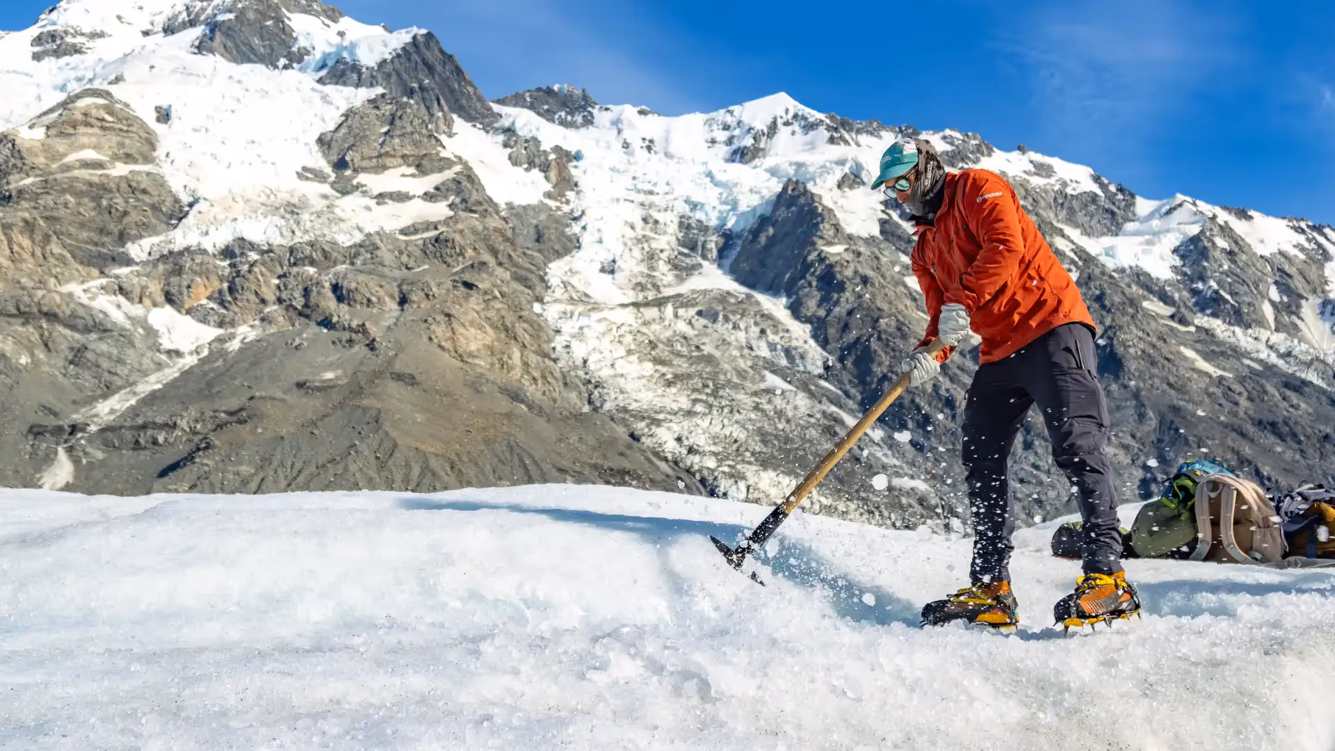 Tasman Glacier Helihike guide cutting steps in ice