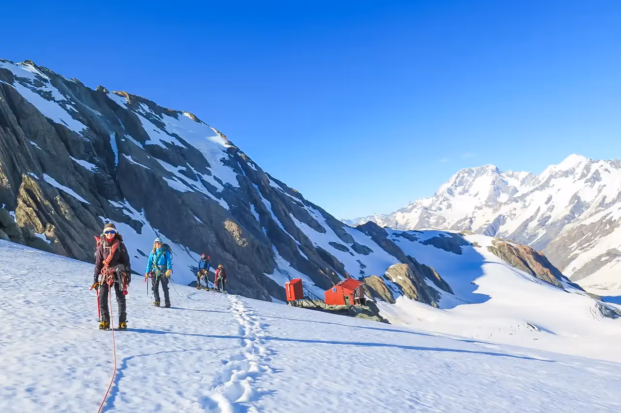 Hochstetter Dome climbers departing Tasman Saddle Hut