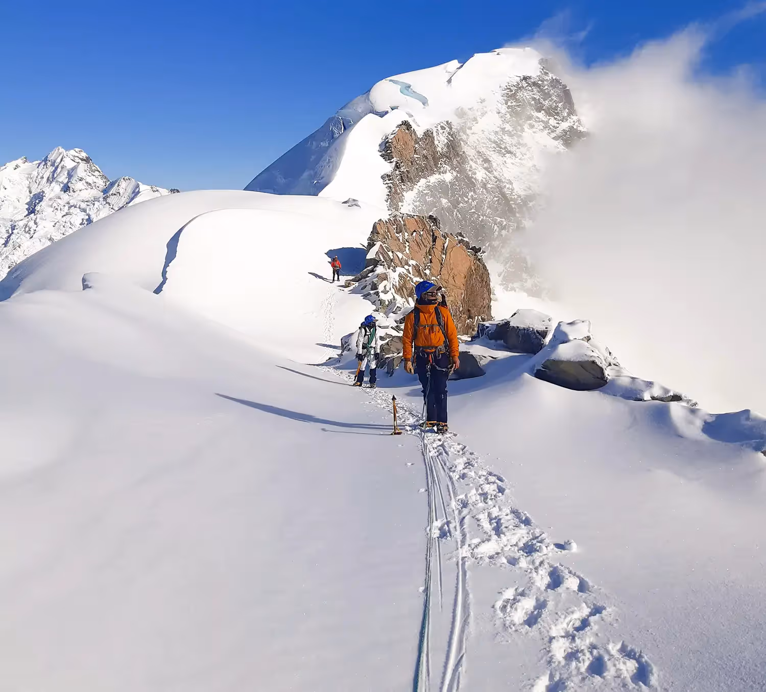 Climber ascending on snowy terrain