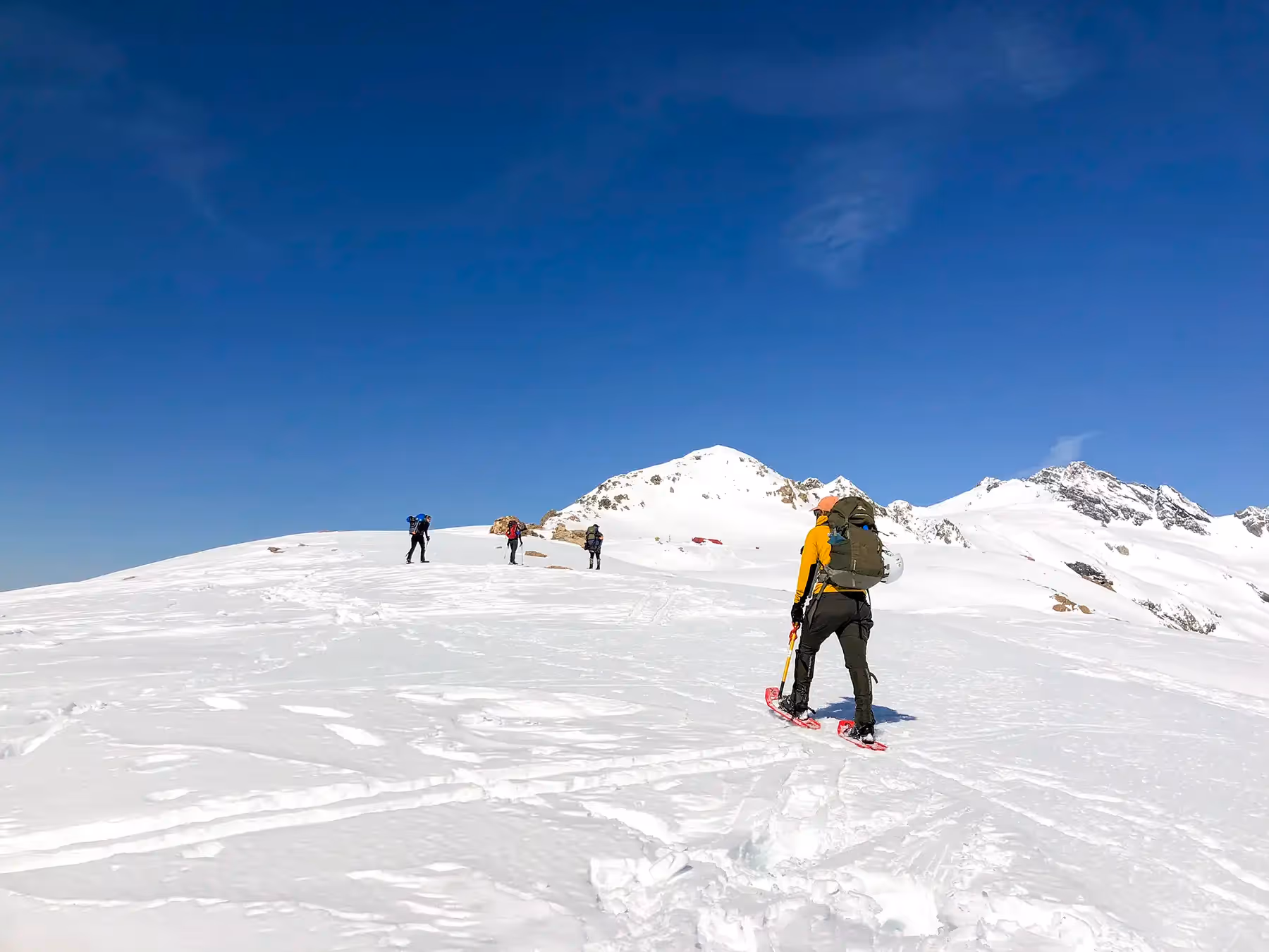Group snowshoeing on a snowy slope