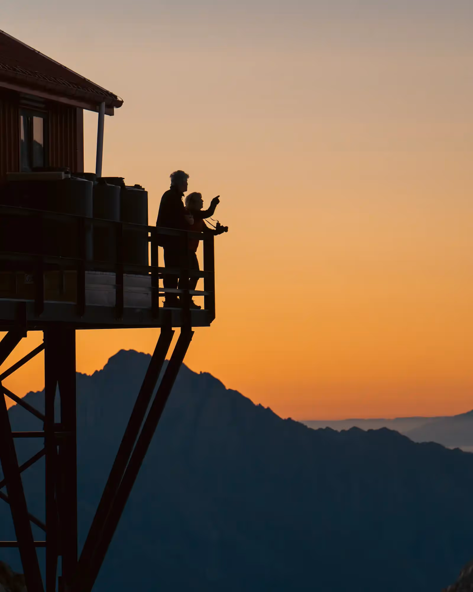 Climbers enjoying sunrise views from Plateau Hut