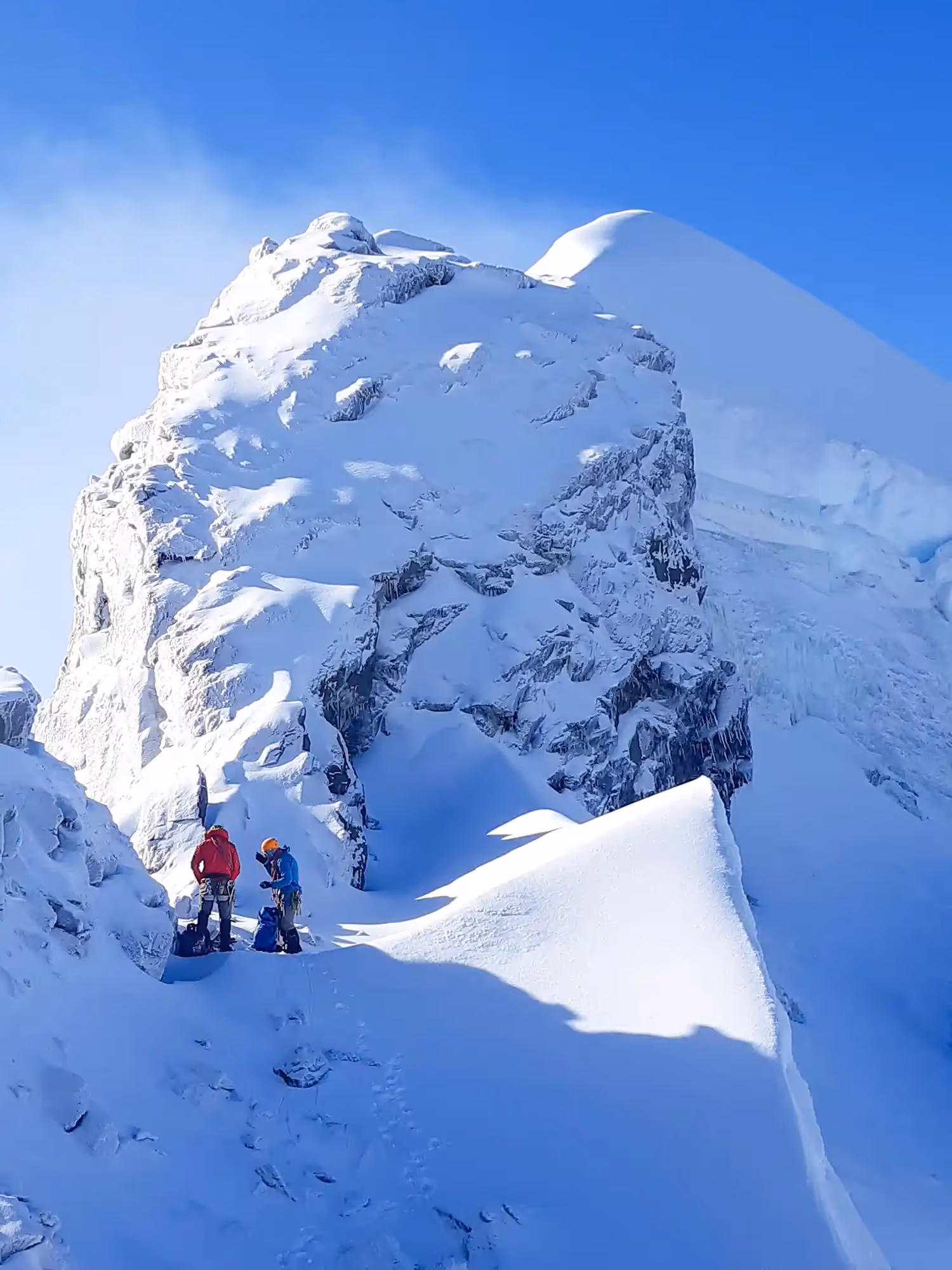 Climbers stopping to rest in the snowy alpine environment