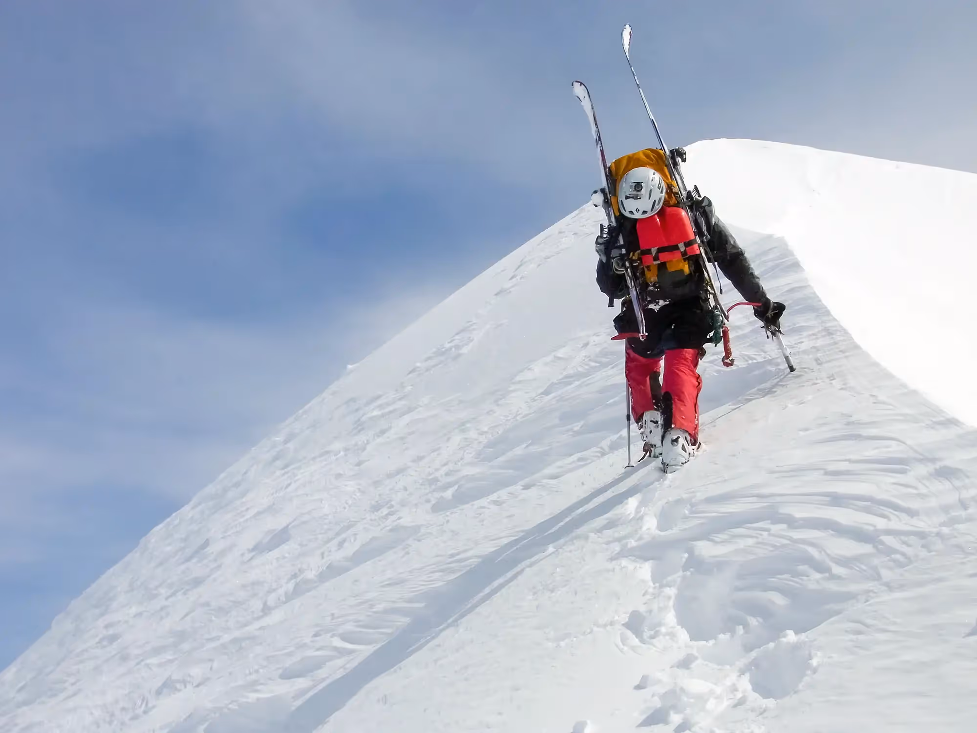 Participants on a Ski Mountaineering course walking near the summit