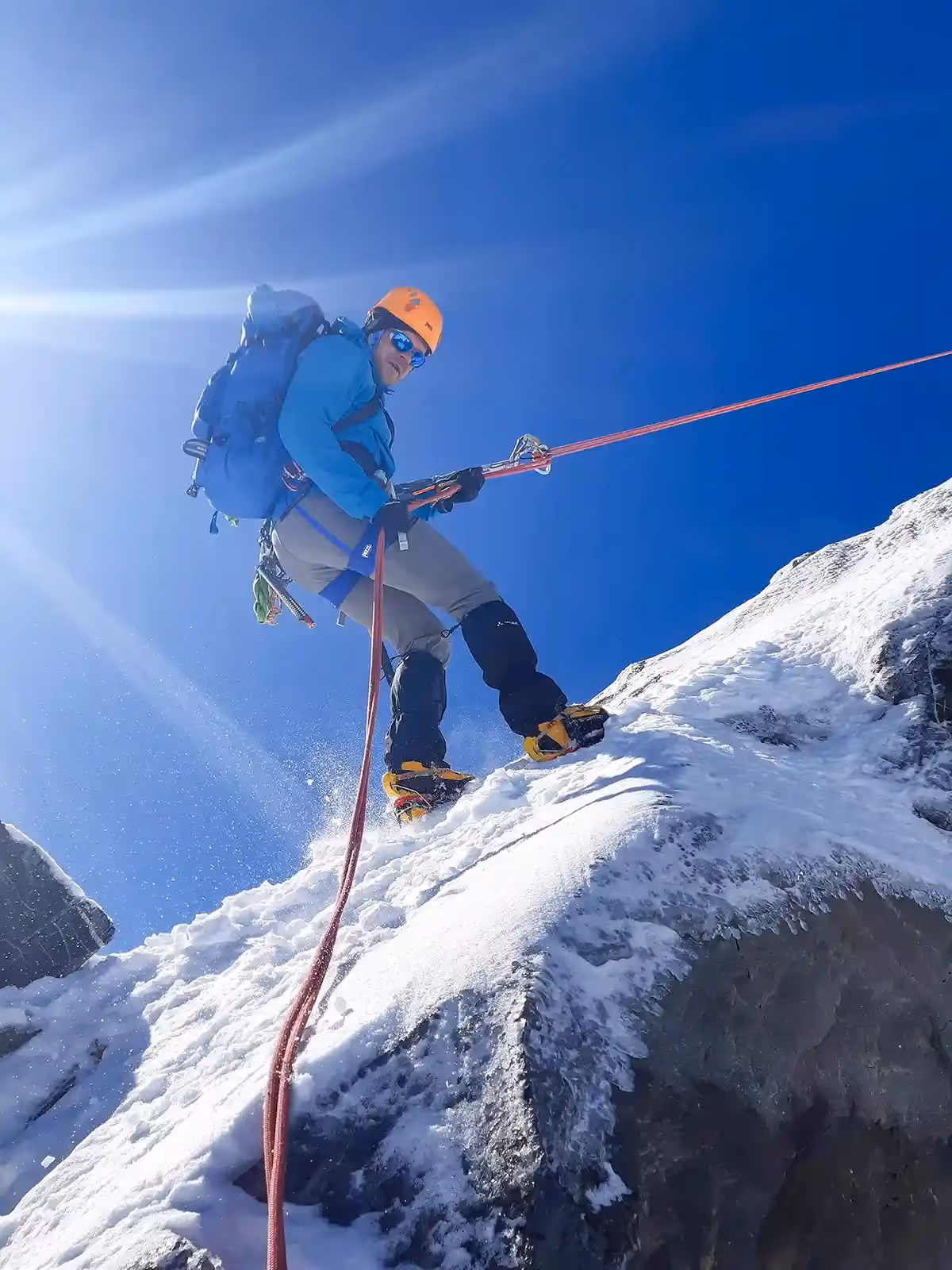 Technical Mountaineering Course climber abseiling down rock face