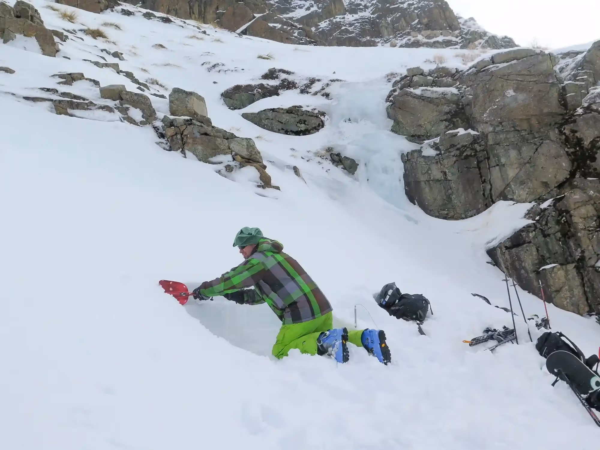Avalanche course participant shovelling snow