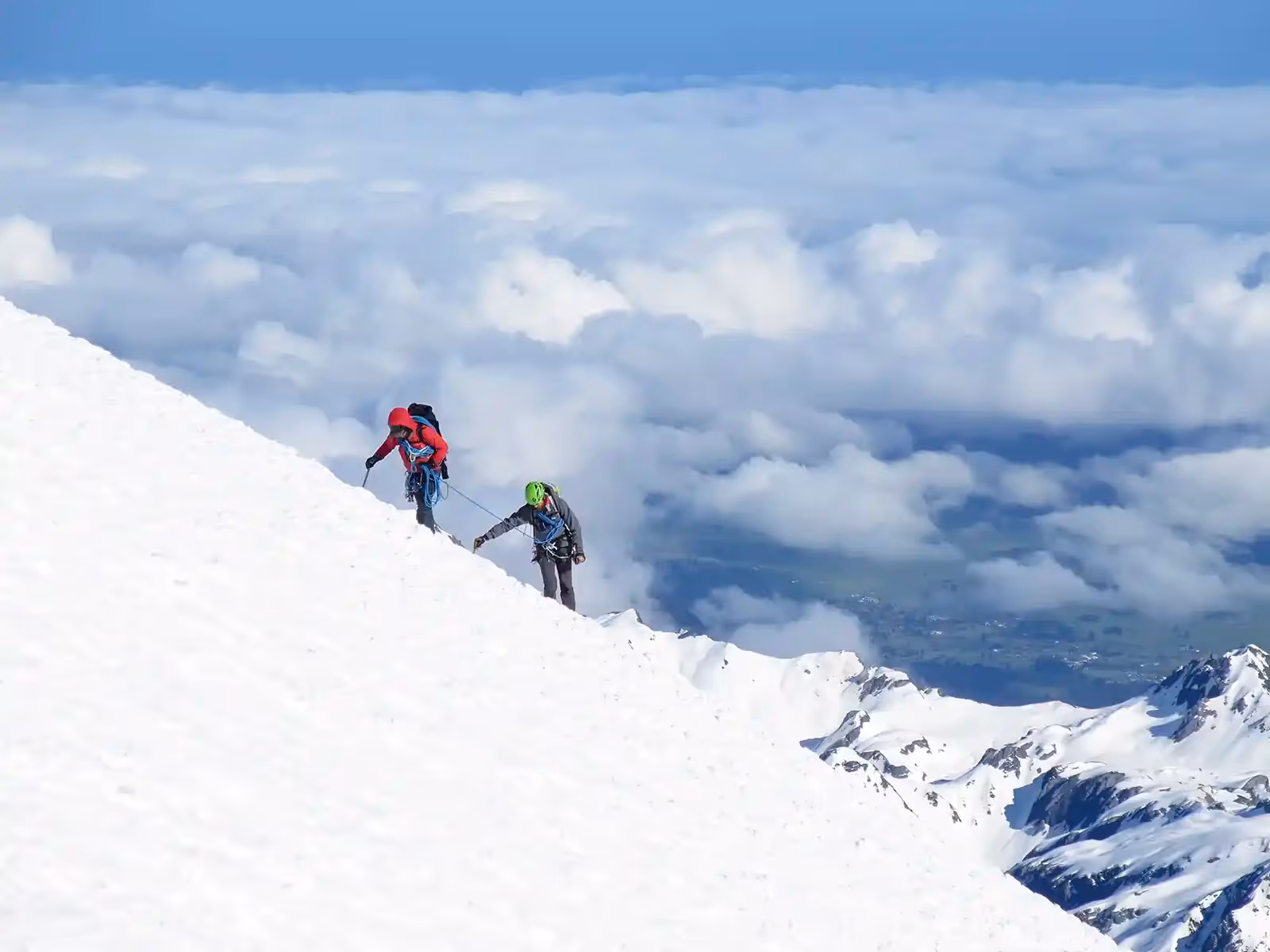 Guide and guest climbing icy slope