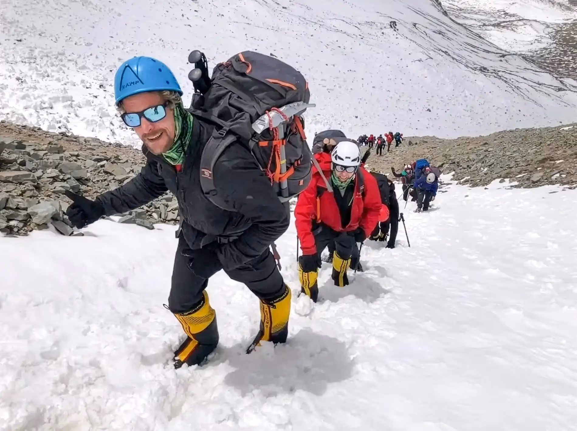 Aconcagua Expedition guide and guests ascending snowy slope