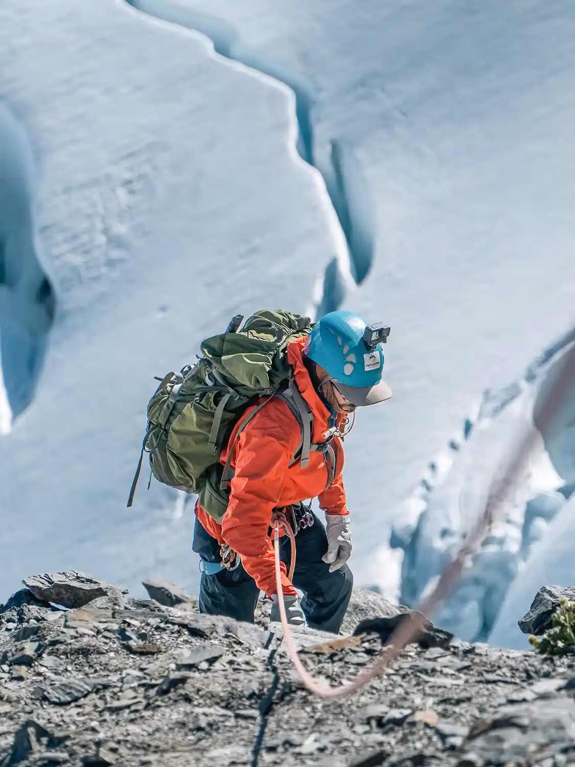 Mount Aspiring Expedition guest roped up ascending rocky terrain