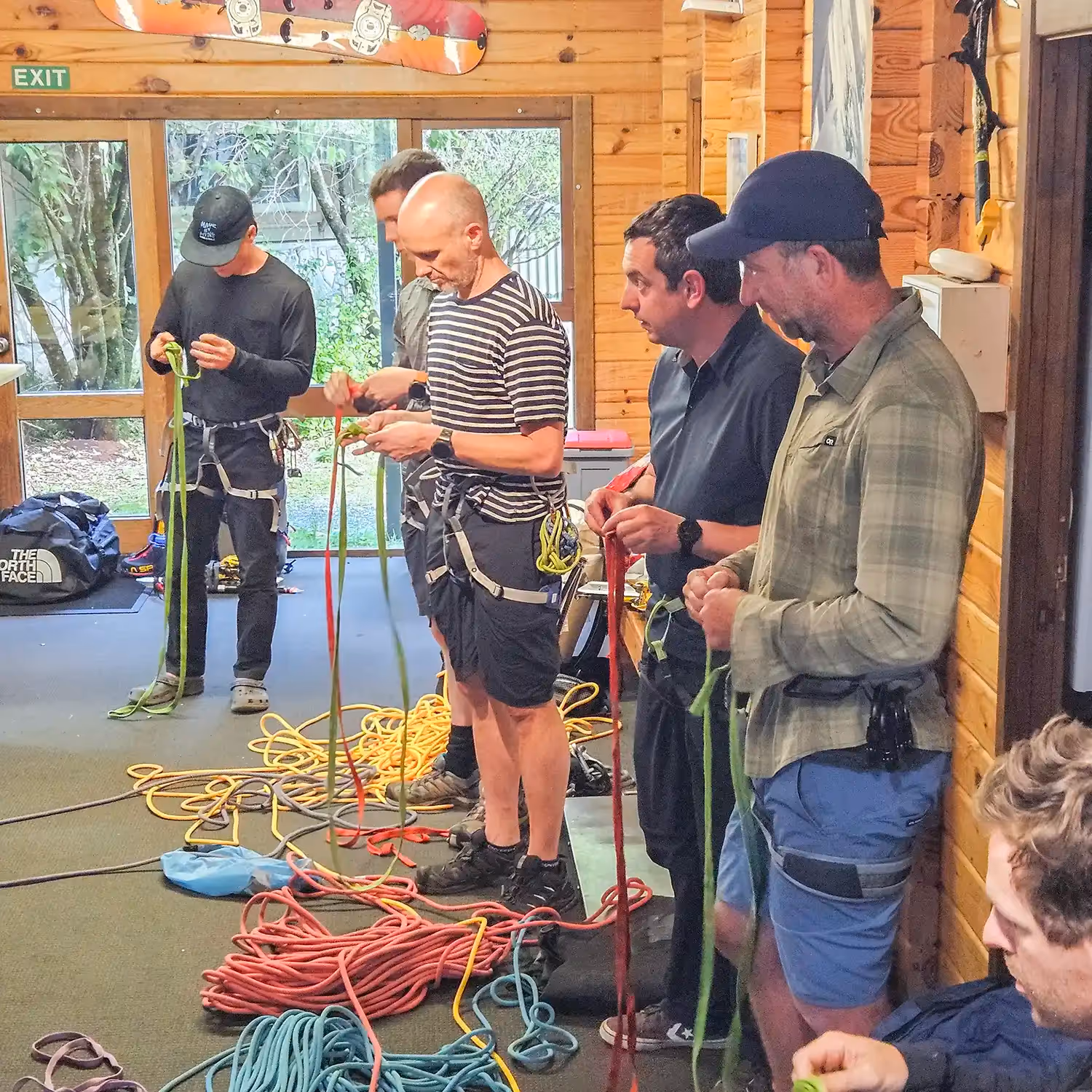 Participants practising rope techniques indoors
