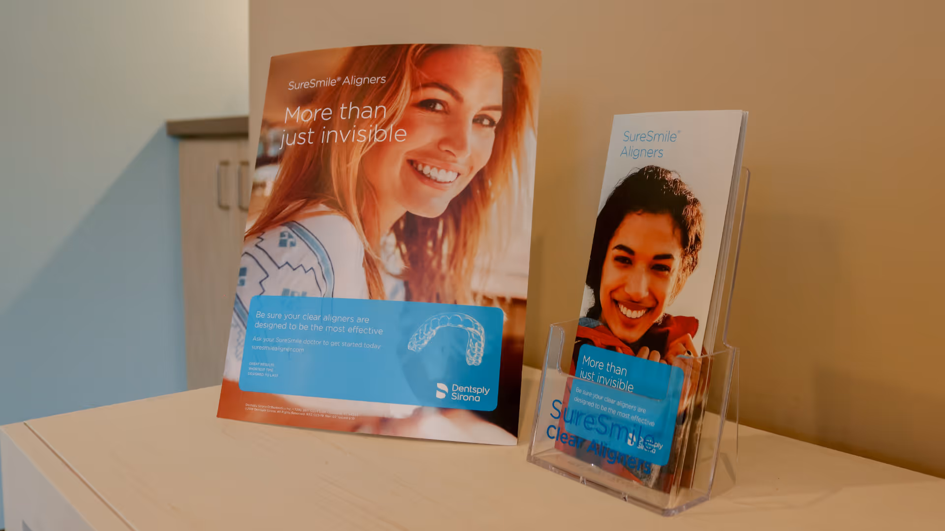 Promotional brochure and leaflet for SureSmile Aligners featuring smiling young people and a clear dental aligner illustration.