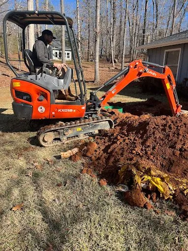 Septic tank repair in north Georgia; digging hole in yard.