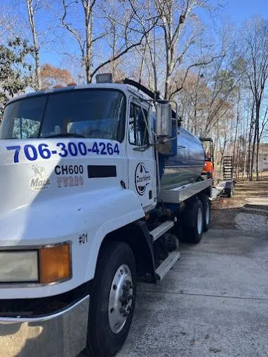 Septic tank installation in north Georgia; septic truck on-site serving client.