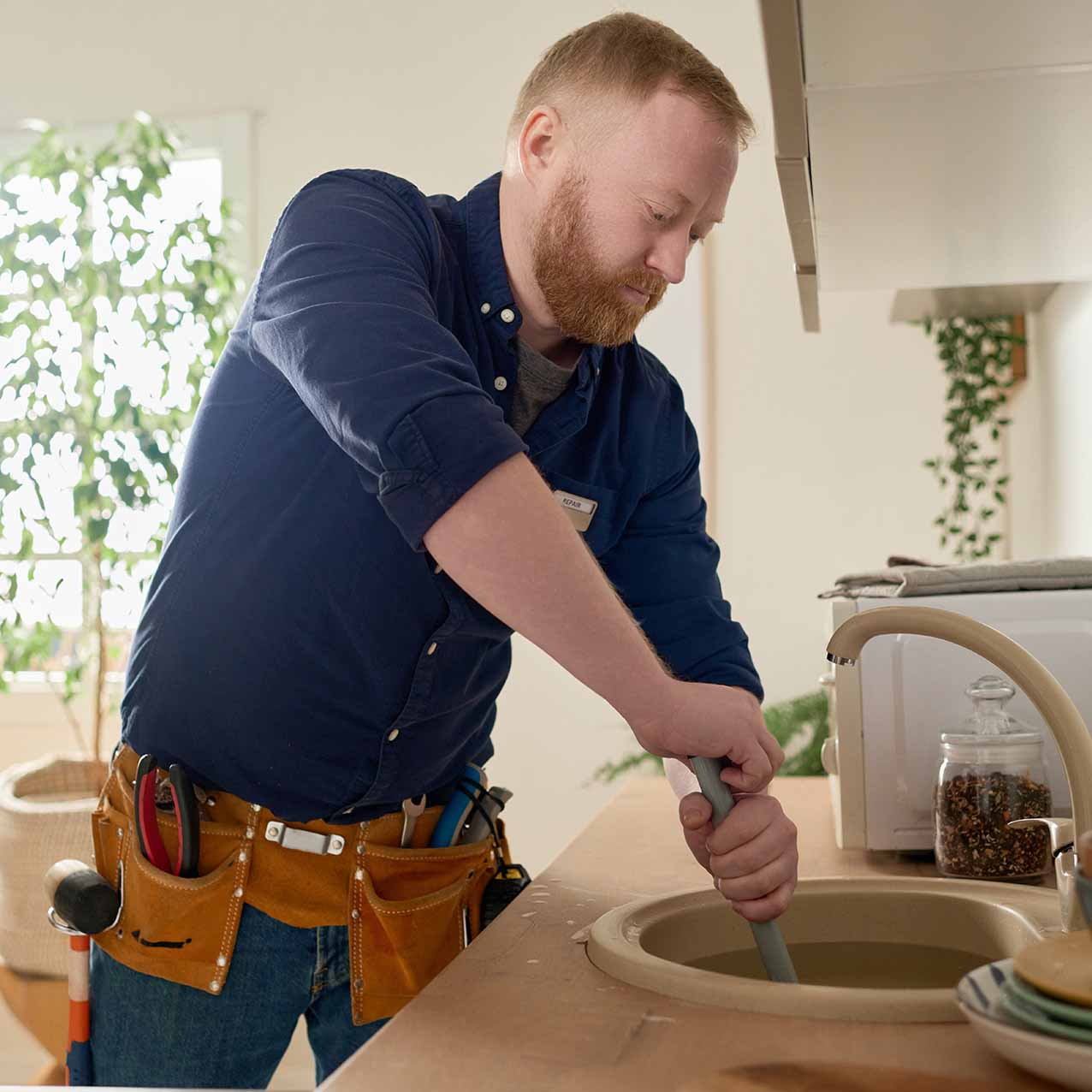 Plumber cleaning a drain in north Georgia.