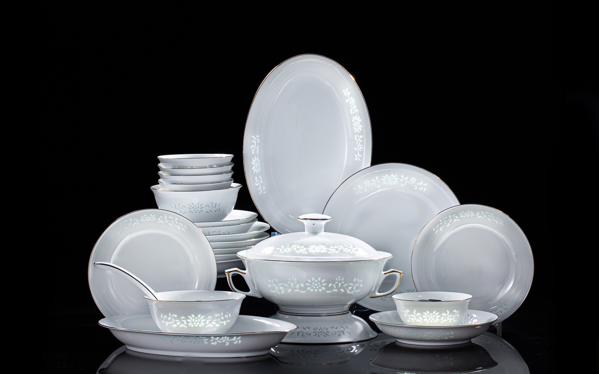 The complete 24-piece Imperiax porcelain set on a black background
