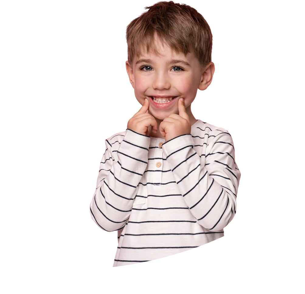 Smiling young boy with brown hair wearing a white long-sleeve shirt with black stripes, using fingers to stretch his smile.