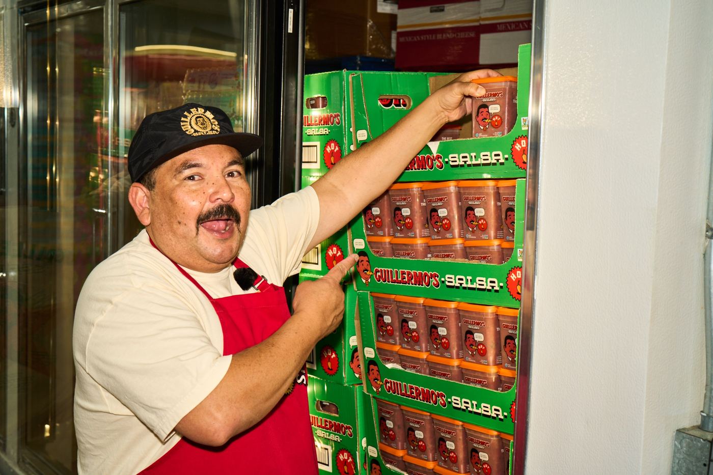 Guillermo pointing at the salsa cold case