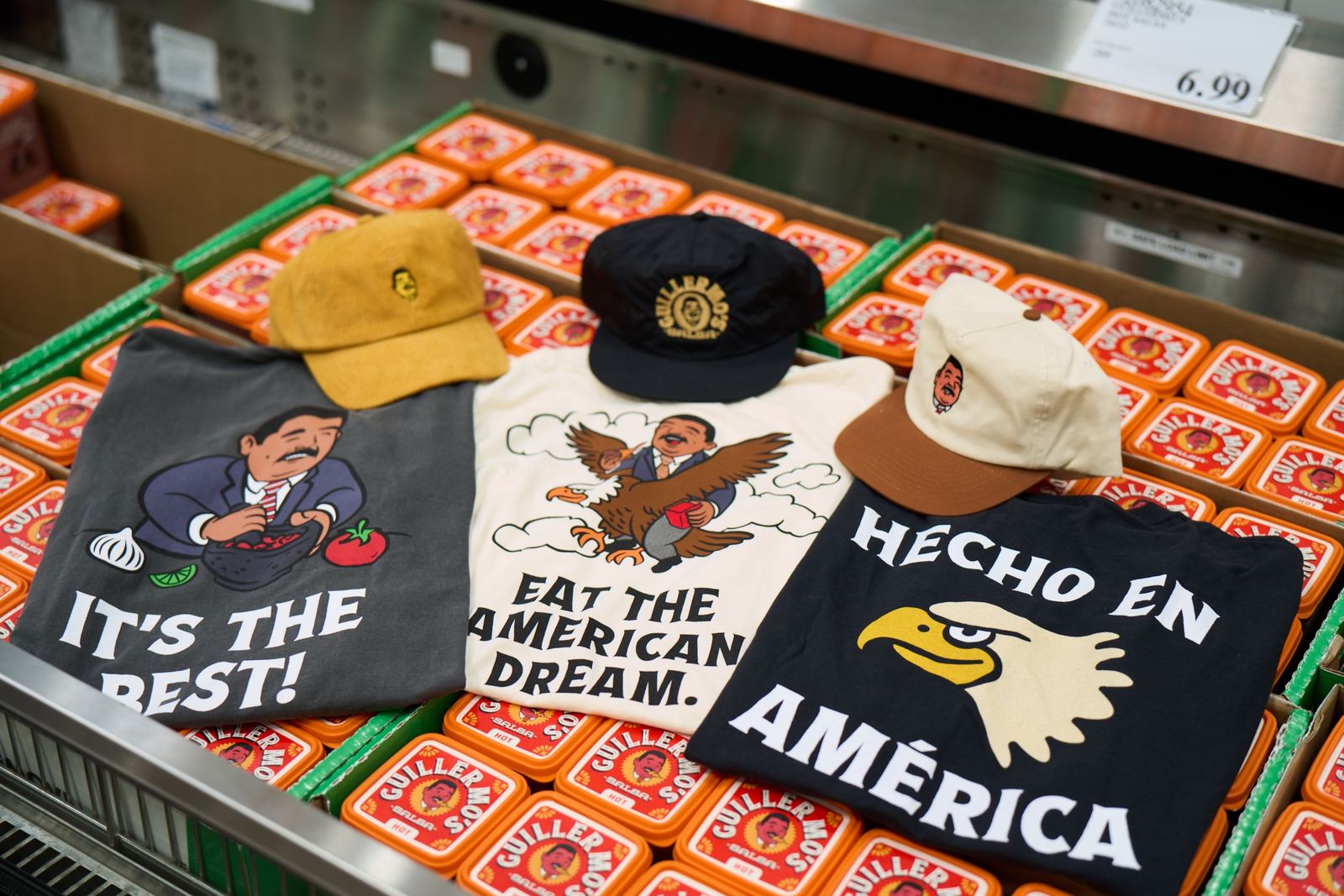 Tees and caps laid out on Guillermo's Salsa boxes