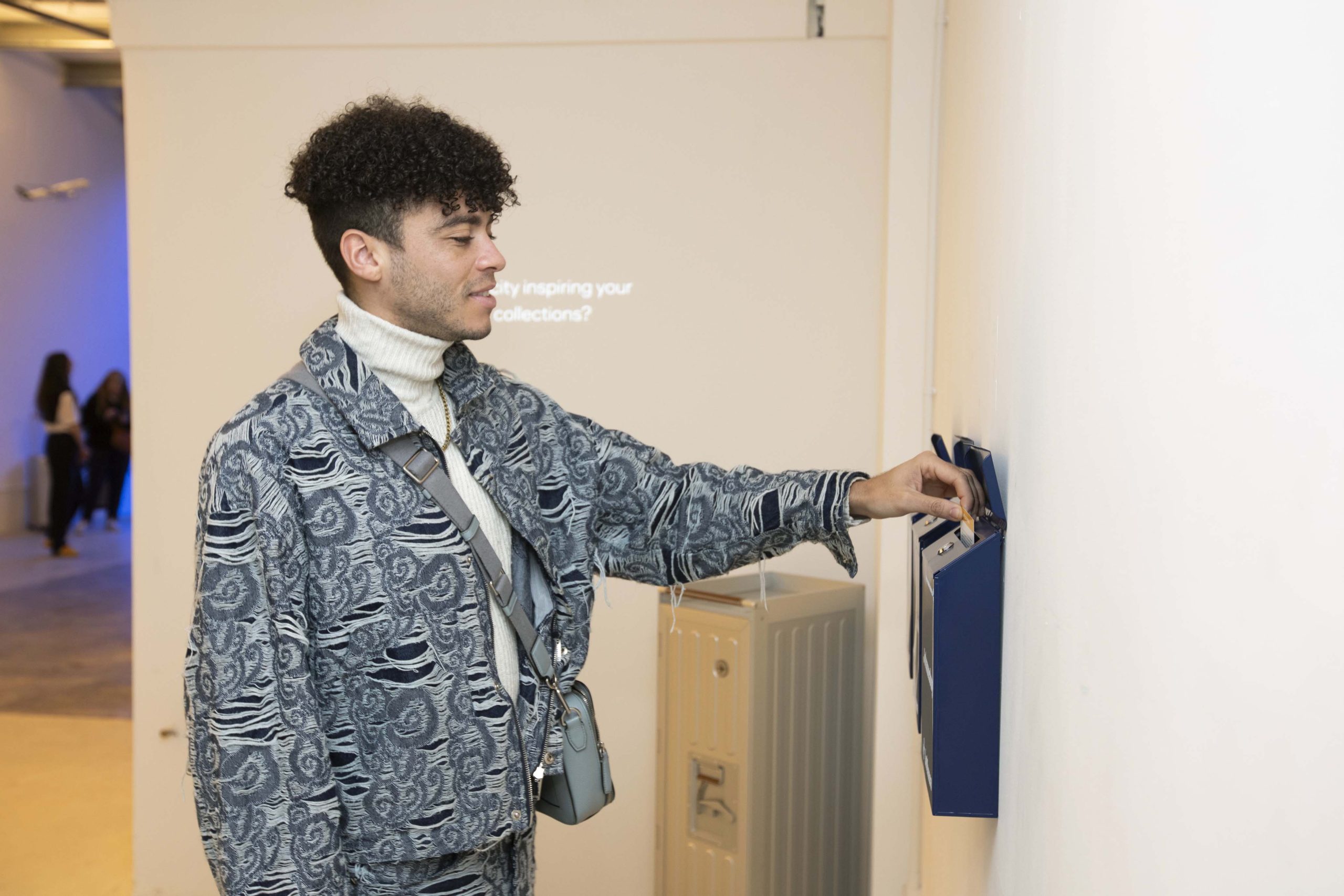 Visitor wearing design jacket interacting with exhibition display at Lufthansa activation