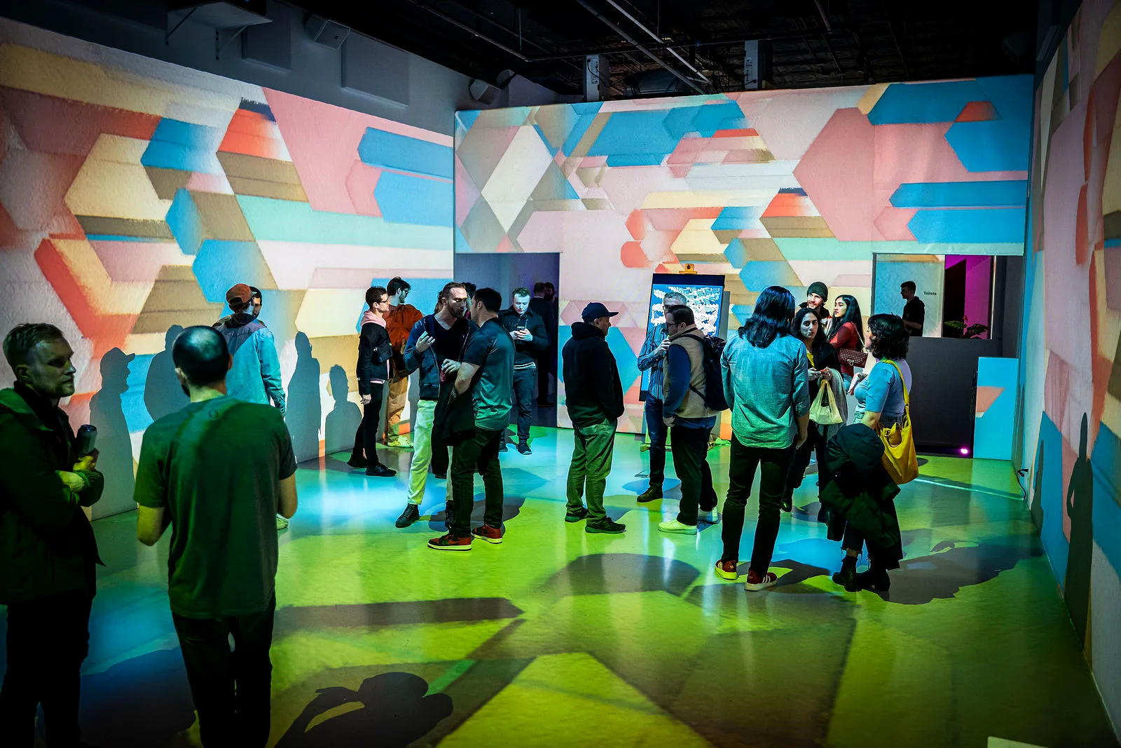 Generative projection visuals and a crowd at LUME Studios