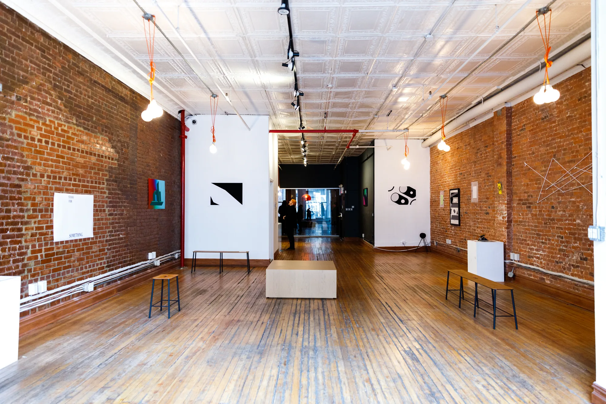 Empty cast-iron loft at 393 Broadway with exposed brick, tin ceiling, and wood floors