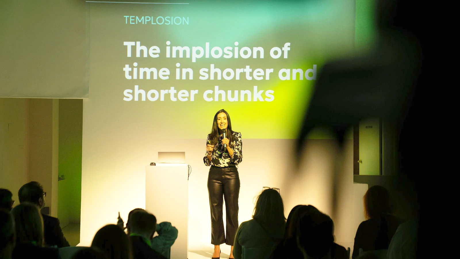 Keynote speaker on stage in front of a projected slide at a Cicero summit produced by LUME Studios