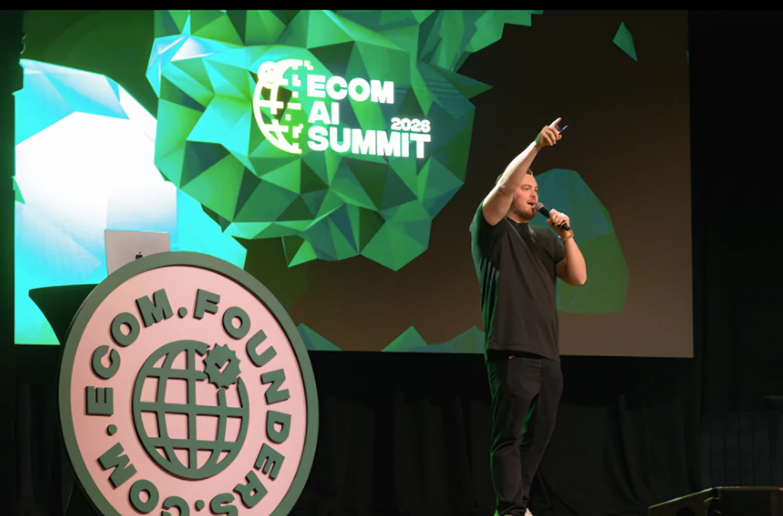 Keynote on the Webster Hall stage in front of the Ecom AI Summit 2026 graphic on the LED wall
