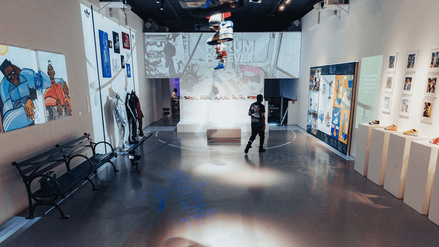 Adidas Originals exhibit with sneaker displays, murals, and suspended shoes at LUME Studios