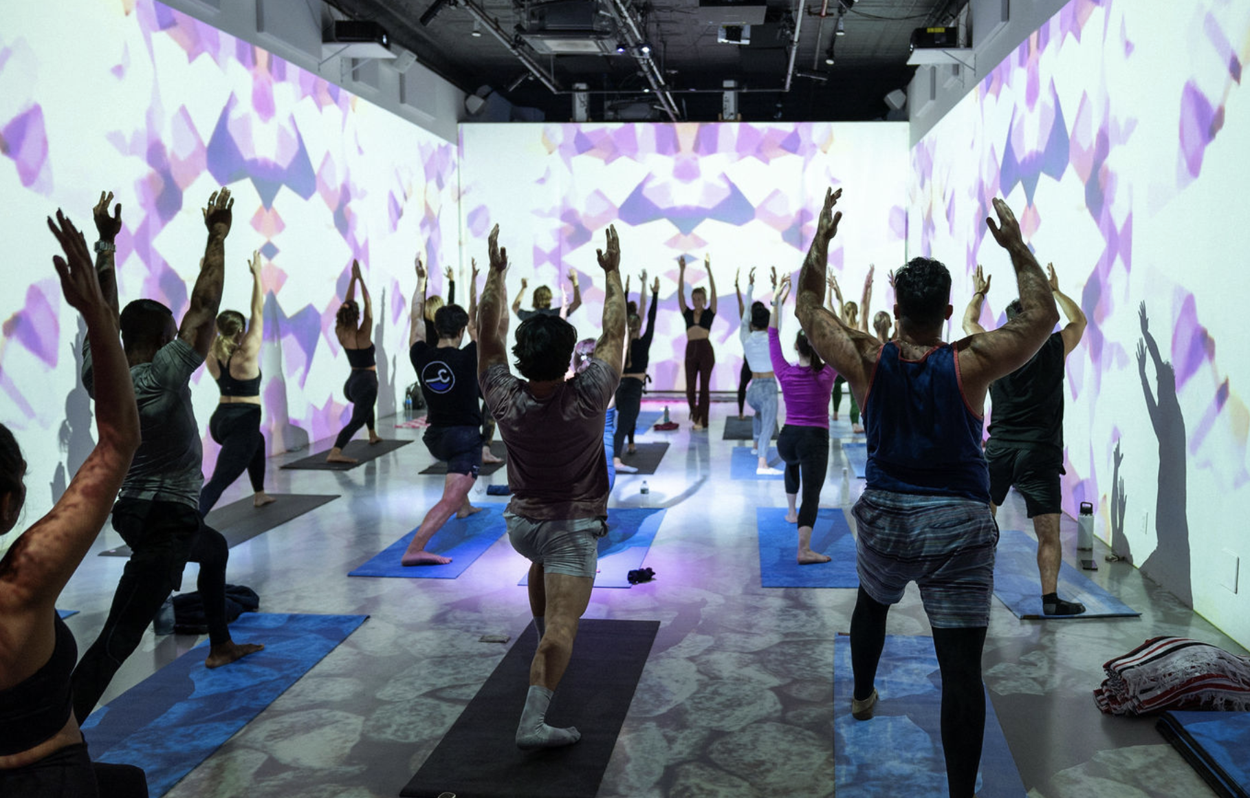 Wellness session surrounded by projected visuals at LUME Studios NYC
