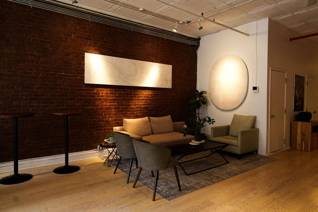 LUME Studios Loft 4 lounge with brick wall art and warm lighting