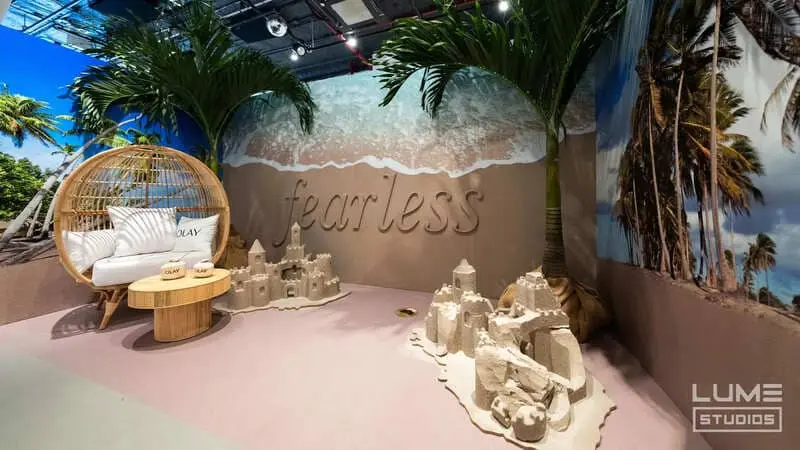 Olay beach-themed brand activation with sand sculptures in the Immersive Studio