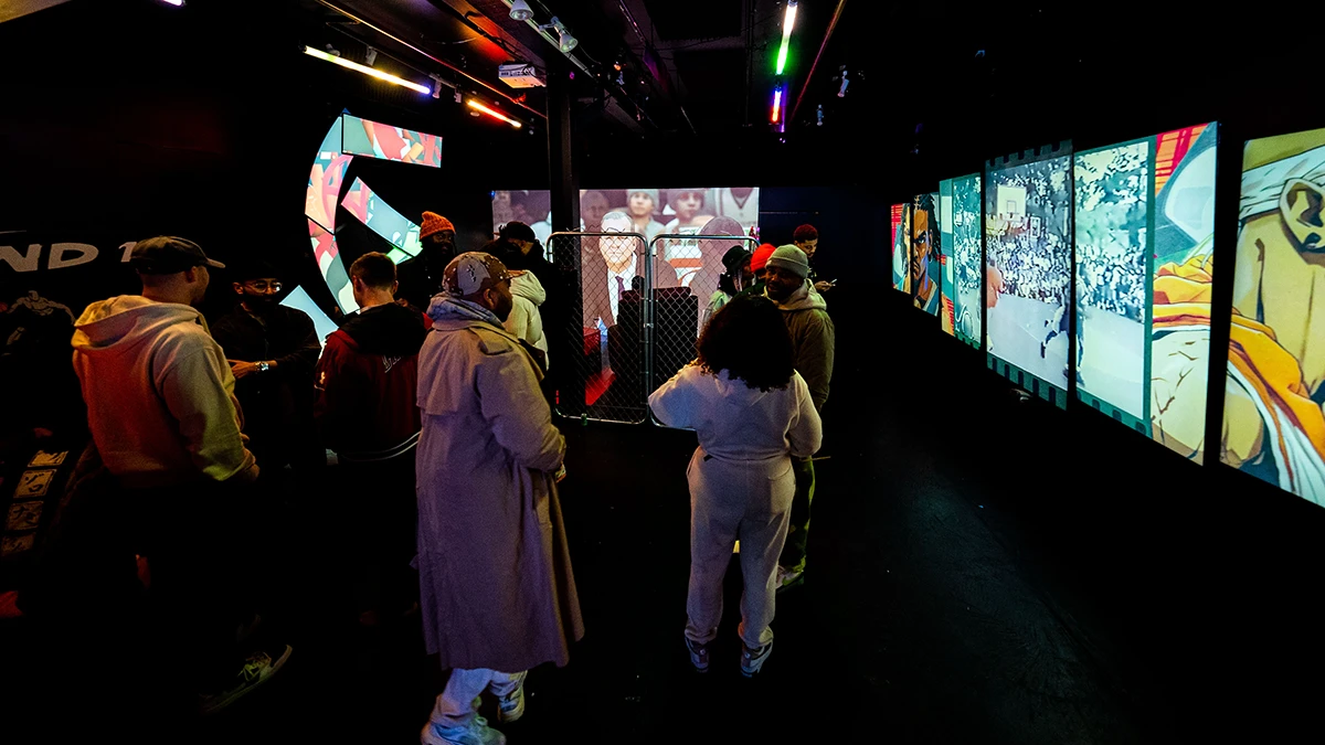 Guests at a custom screen installation in the Basement Lounge