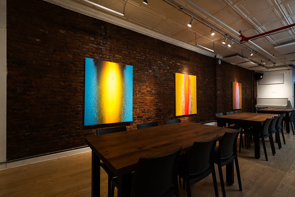 LOFT 4 dining room set with long tables, brick walls, and hanging art