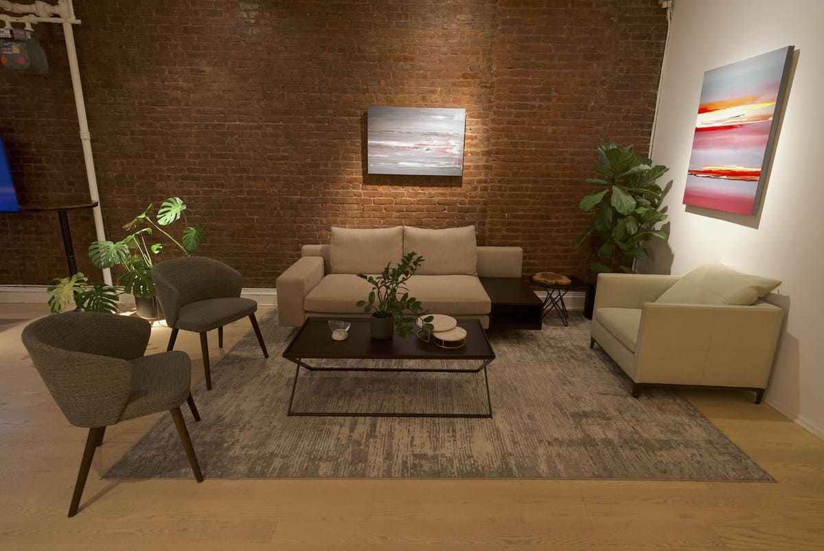 LOFT 4 lounge area with sofas and art on brick